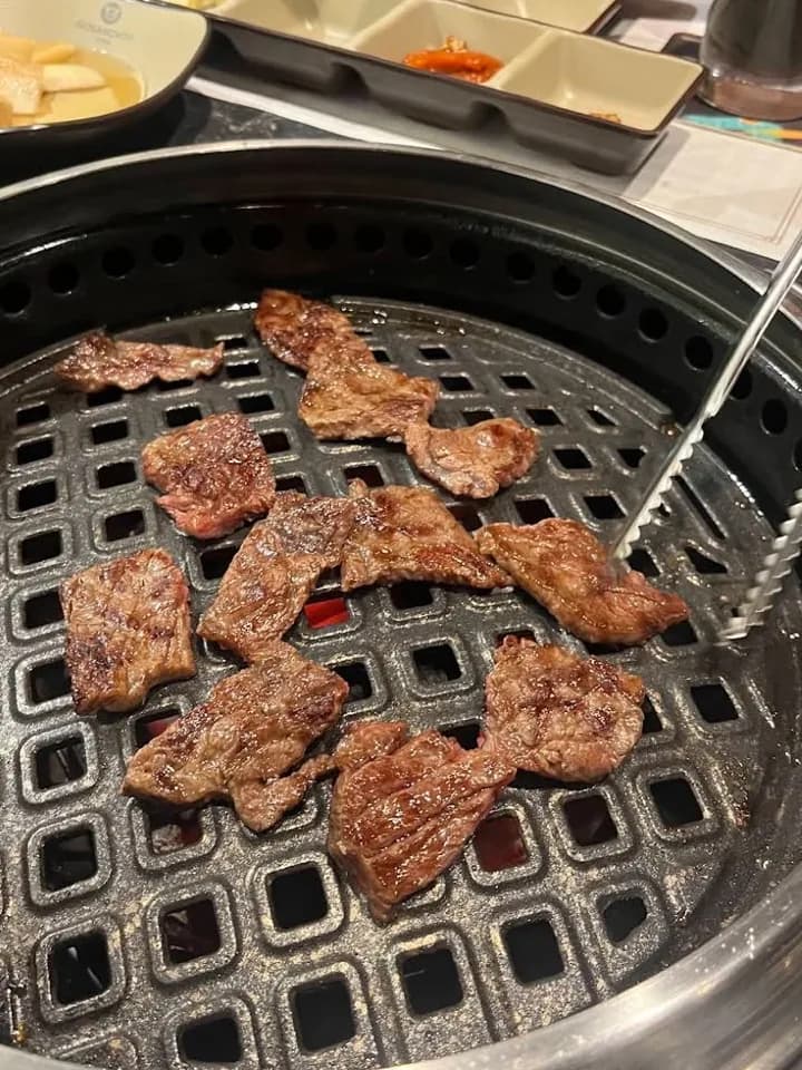 GOSANCHON — beef pieces grilling over charcoal