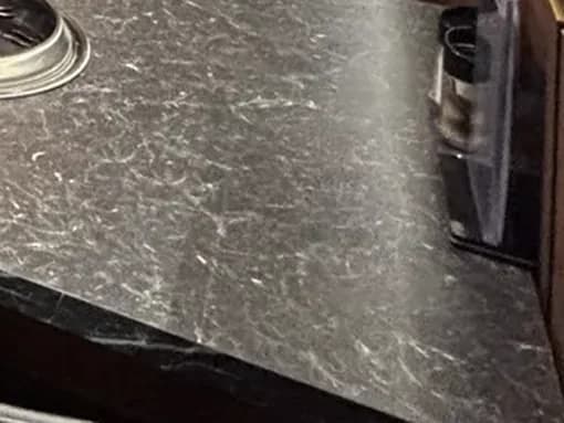 Black marble table top veined in white at GOSANCHON