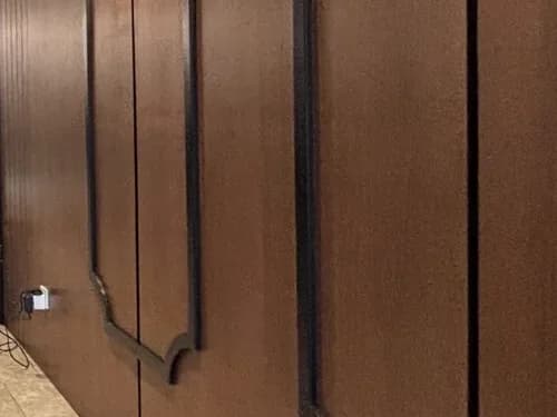 Walnut wall panelling with slim dark trim at GOSANCHON